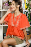 Rust embroidered tie front blouse